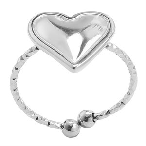 Detail of silver puffed heart ring showing adjustable open band and diamond-cut texture