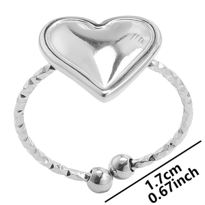 Detail view of adjustable silver heart ring with textured band and 1.7cm diameter