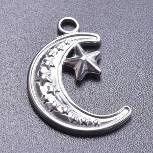 Macro view of stainless steel crescent moon and star pendant charm with metallic luster