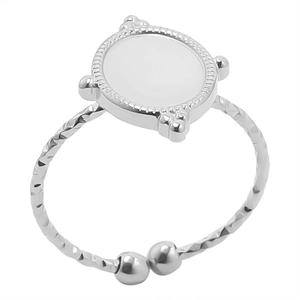 Detailed macro view of silver steel ring featuring white enamel disc and beaded border