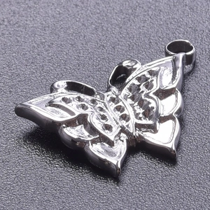 Vue détaillée d'un pendentif papillon en acier inoxydable argenté avec motifs ajourés