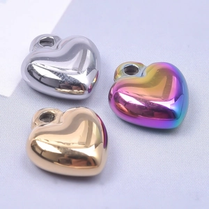Detailed view of heart-shaped pendants in silver, gold, and rainbow mirror finishes