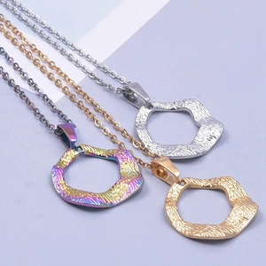Detail of 18k plated stainless steel necklaces showing lava texture and various finishes