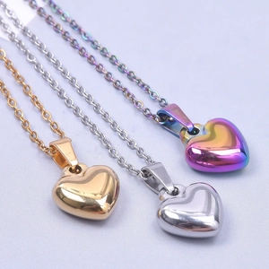 Polished heart pendants in gold, silver, and rainbow plating on slim necklaces
