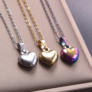Three-color set of polished 3D heart pendants in silver, gold and iridescent finishes