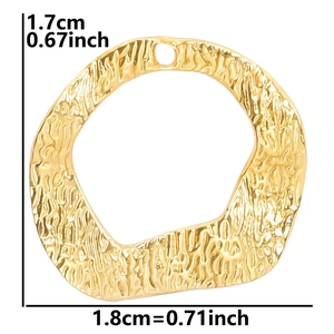 Macro detail of gold irregular round pendant with hammer texture and size 1.7x1.8cm