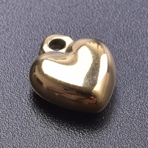 Macro detail of a 18k gold plated stainless steel 3D heart-shaped pendant for DIY jewelry