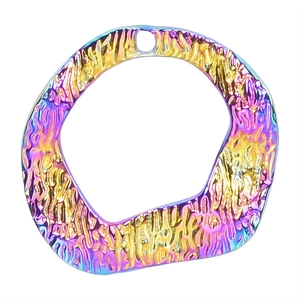 Macro shot of an irregular lava-textured stainless steel pendant with rainbow plating
