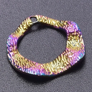Macro shot of an irregular rainbow plated stainless steel pendant with a hammered texture