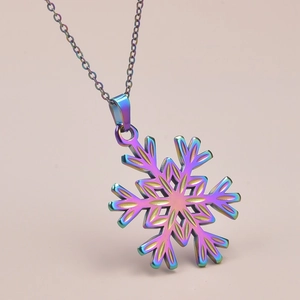 Detailed macro view of an iridescent rainbow snowflake pendant necklace with thin metal chain