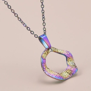 Detail of iridescent geometric hollow pendant necklace with hammered metal texture