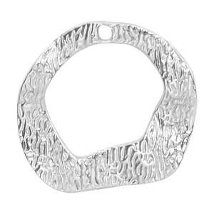 Macro detail of irregular hammered silver pendant showing metallic texture and DIY hole