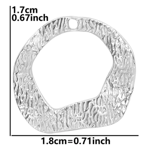 Close-up of silver irregular round pendant with hammered texture for DIY jewelry making