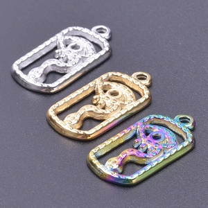 Detail of gothic stainless steel pendants with snake and skull design in three colors