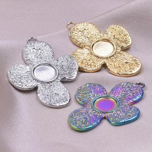 Macro shot of 18k plated flower charms with center setting on purple satin