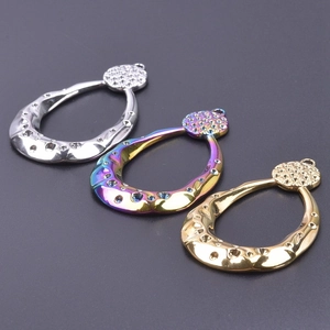Macro detail of tear-drop metal pendants with hammer-textured finish and hanging rings