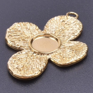 Detailed macro view of 18k gold plated stainless steel four-petal flower pendant charm