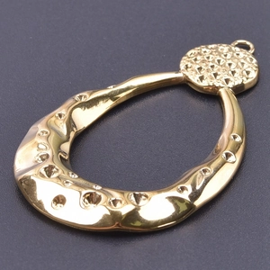 Detailed macro view of 18k gold plated teardrop frame pendant for DIY necklace making