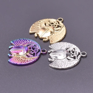 Detailed macro view of Egyptian beetle charms in gold, silver, and iridescent purple finish