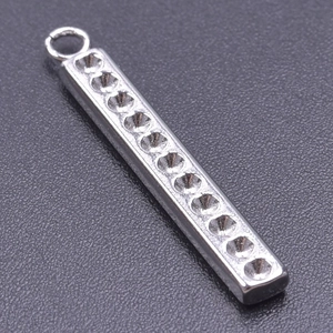 Detailed macro view of silver stainless steel 11-hole rectangular bar pendant for DIY jewelry