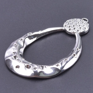 Polished stainless steel teardrop pendant with textured circular dimples and silver finish
