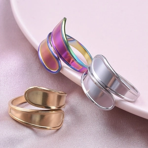 Three minimalist wide band geometric stainless steel rings in iridescent, gold, and silver finishes
