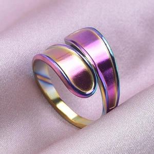 Macro shot of wrap-around stainless steel ring with rainbow iridescent plating