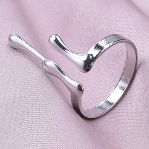 Macro detail of silver irregular lava style adjustable ring on purple silk fabric