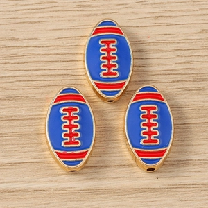 Three enamel American football charms for jewelry making on light wood background