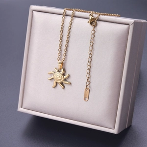Detail of 18k gold plated stainless steel sun pendant with lobster clasp and extension chain