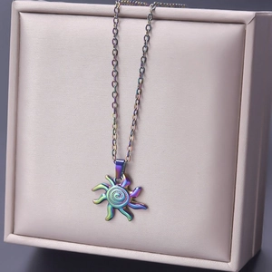 Detailed macro view of iridescent sun pendant with spiral texture on gold O-chain necklace