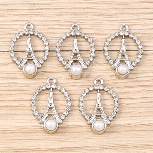 Detailed view of silver Eiffel Tower charms with rhinestones and white pearls set of 5