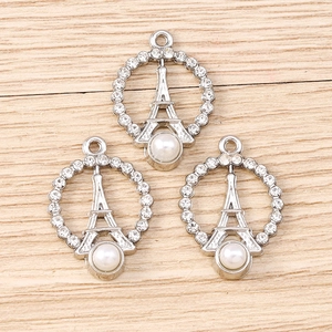 Detailed view of silver Eiffel Tower pendants with faux pearl and crystal rhinestones