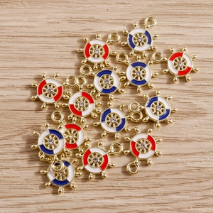 Detailed view of alloy enamel ship wheel pendants with red and blue rhinestones