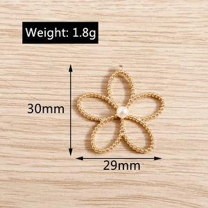 Detailed view of gold pearl hollow plum blossom charm with dimensions 30mm x 29mm