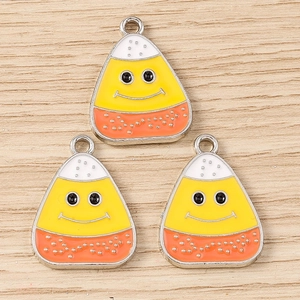 Three pieces of candy corn enamel pendants with smiley faces for DIY jewelry making