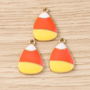 Detail of three enamel candy corn charms with gold alloy frame for DIY jewelry making