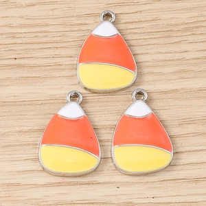 Three colorful candy corn pendants in white orange and yellow for DIY jewelry making