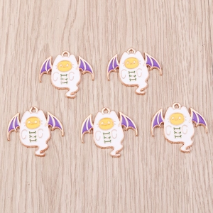 Flat lay of five enamel cat ghost charms with purple bat wings for DIY Halloween jewelry