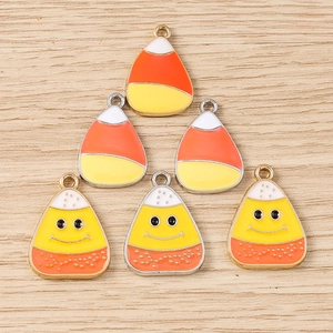Vibrant candy corn enamel charms with smiling faces for DIY Halloween jewelry sets