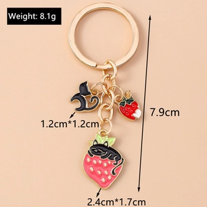 Detail view of cartoon black cat and strawberry keychain with dimensions and weight