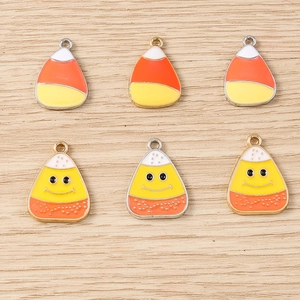 Detail of candy corn enamel pendants for DIY jewelry with classic and smiley faces
