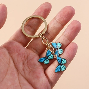 Porte-clés papillon tendance avec pendentifs dégradés bleu-vert et anneau doré