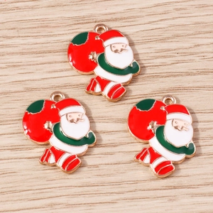 Detailed macro view of three enamel Santa Claus charms for DIY jewelry making