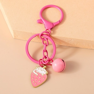 Cute pink strawberry cat keychain with bell and lobster clasp on aesthetic display