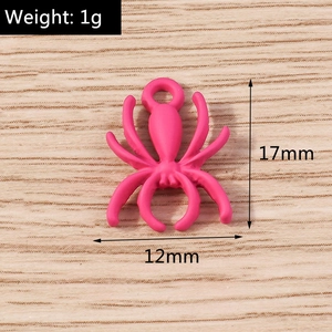 Close-up of a matte pink spider charm pendant for DIY jewelry making with dimensions