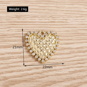 Macro detail of gold quilted heart pendant with sparkling rhinestones and dimensions