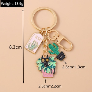 Detailed view of alloy enamel keychains featuring cat cactus and RIP gravestone charms