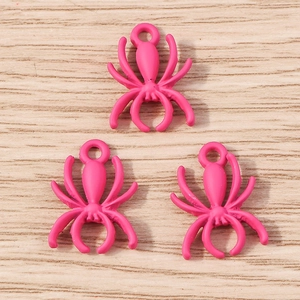 Detail of pink alloy spider charms with matte finish for DIY jewelry making