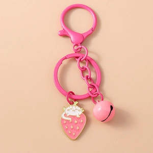 Detail of pink strawberry cat enamel charm with golden bell and metal keyring